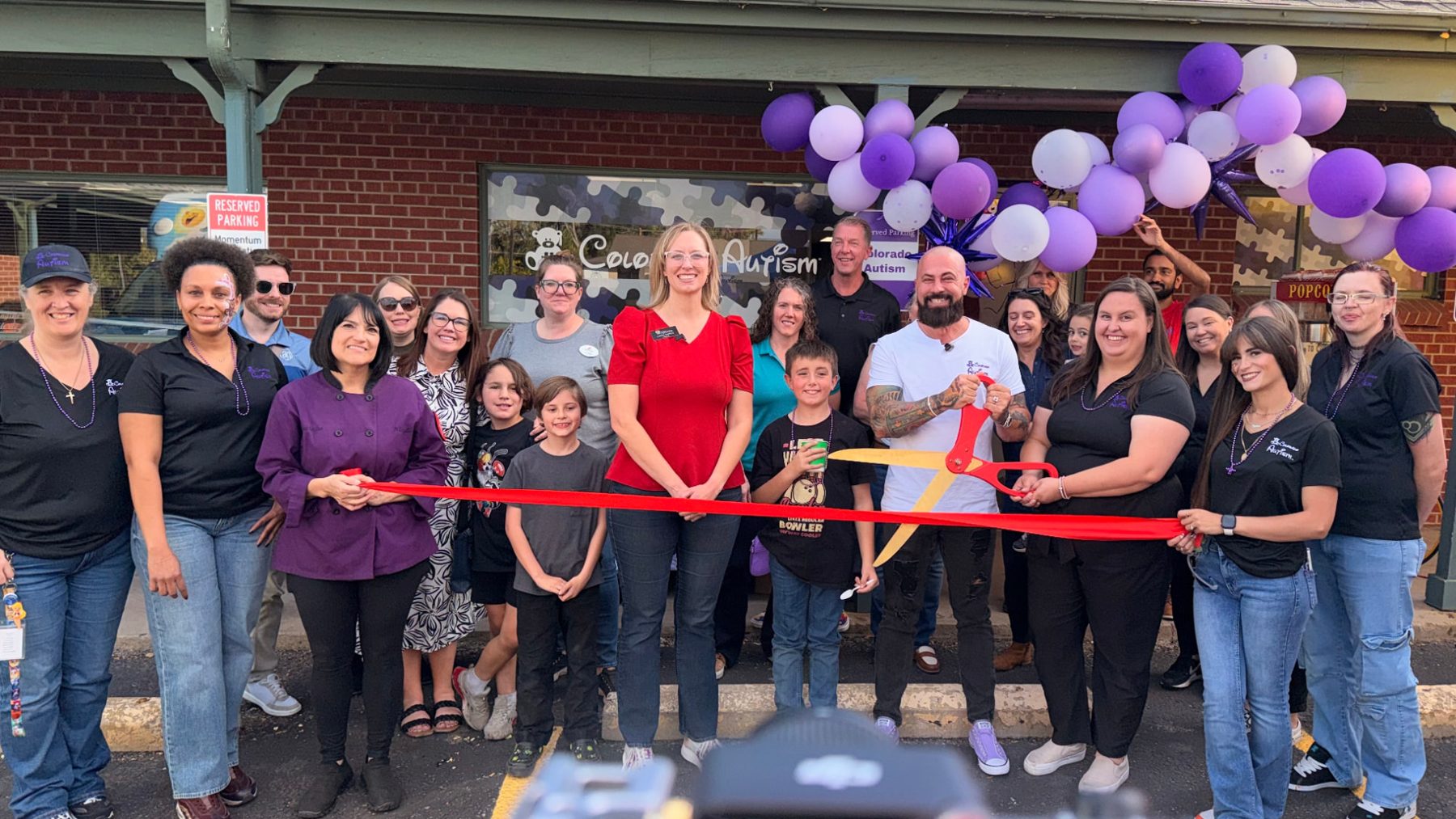 Arvada Mayor Lauren Simpson, Ryker, staff, and families at the Colorado Autism ribbon cutting